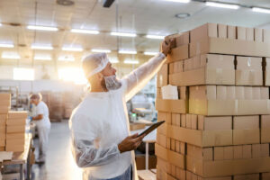 A man checks food packaging.