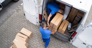 men loading brown boxes into a white van