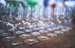 a bunch of wine glasses lined up and sitting on a table